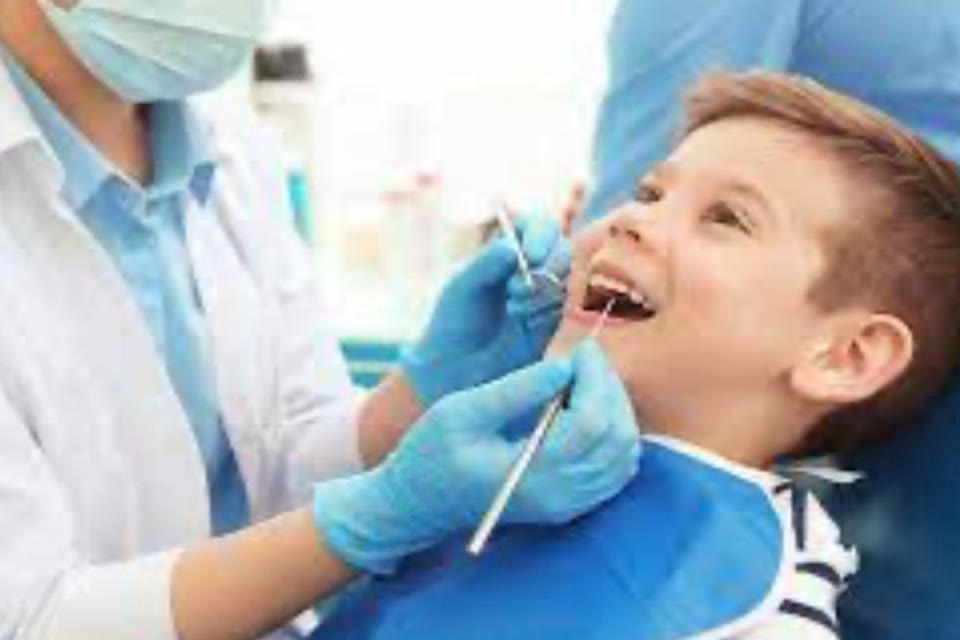 Dentist examining a child's teeth